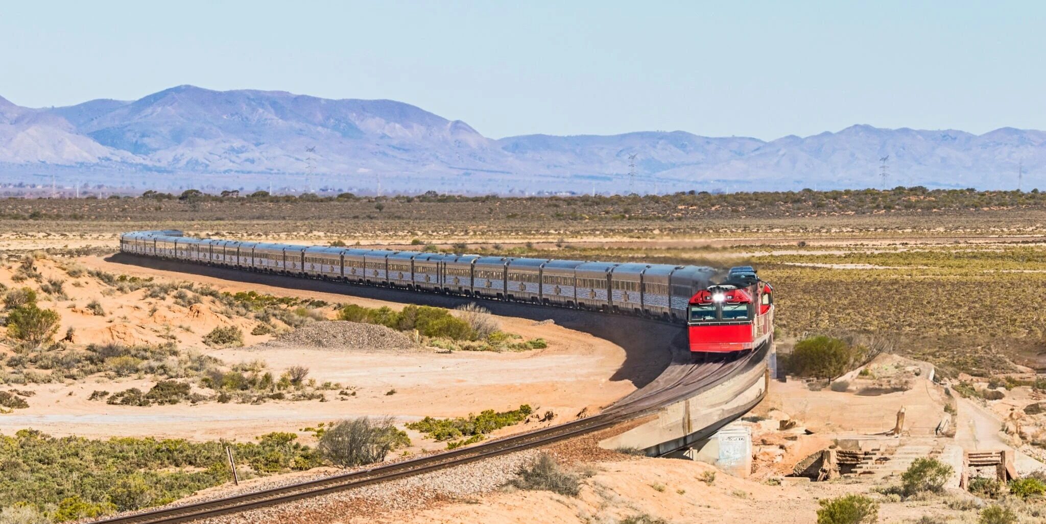 Rail infrastructure crossing a desert landscape
